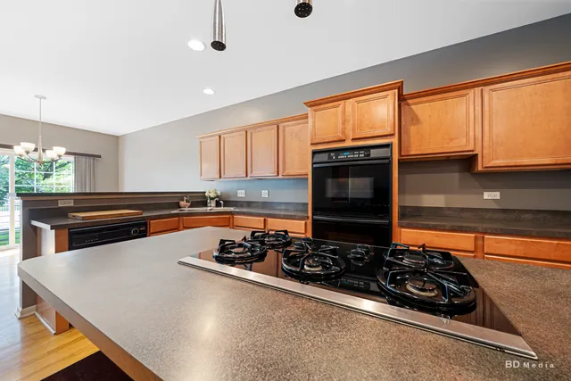 a kitchen with stainless steel appliances a stove a sink and a microwave
