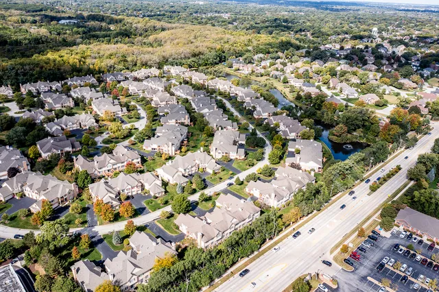 an aerial view of residential houses with outdoor space