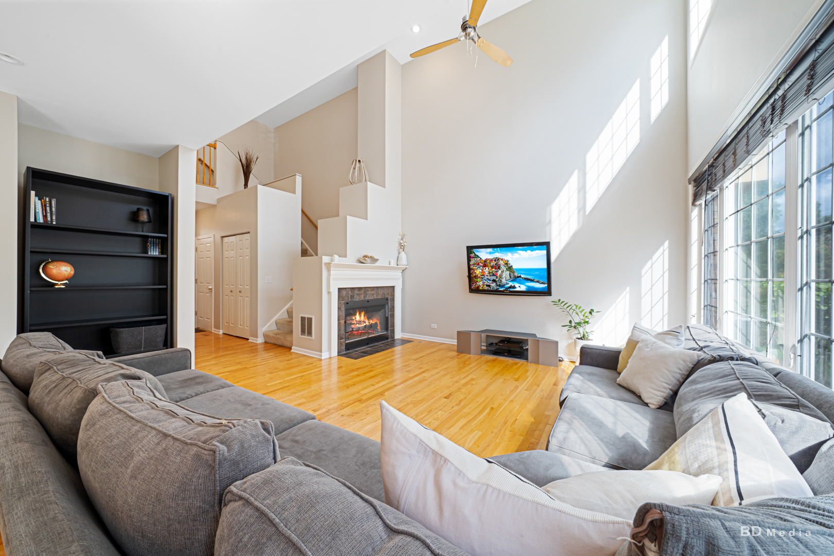 1603 Spyglass Circle Palos Heights, IL 60463 - Photo 10 of 51 a living room with furniture a flat screen tv and a fireplace