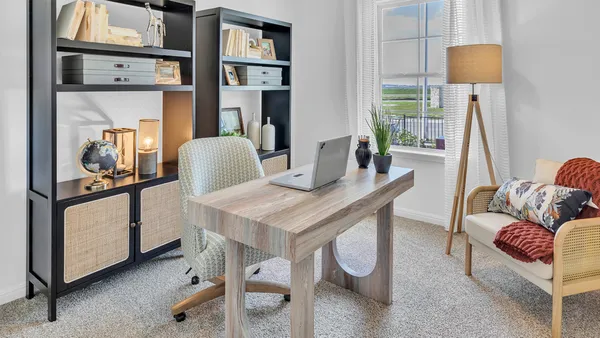 a living room with furniture and paintings on the wall