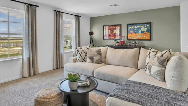 a living room with furniture and a potted plant