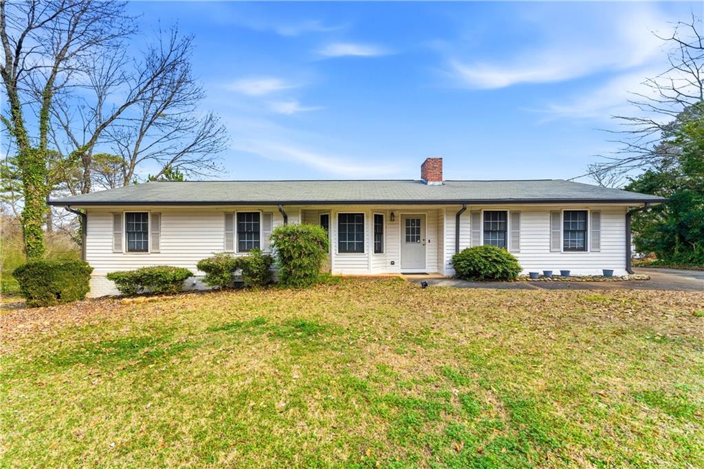 4076 Burnt Hickory Road Northwest Marietta, GA 30064 - Photo 1 of 1 a front view of a house with a yard
