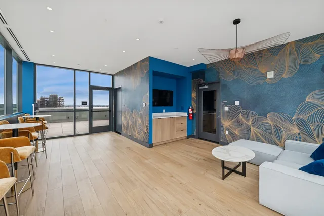 a living room with furniture and a lamp