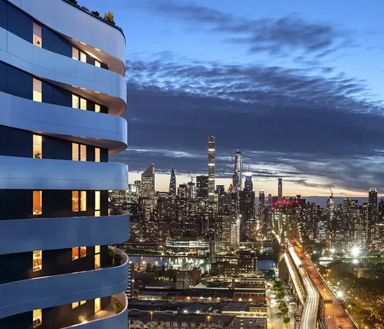 a living room with furniture a rug and kitchen view
