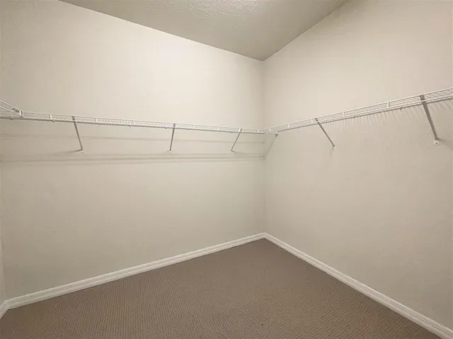 a bathroom with a granite countertop tub sink shower and mirror