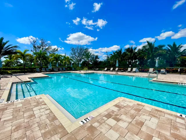 a front view of a house with a yard and fountain