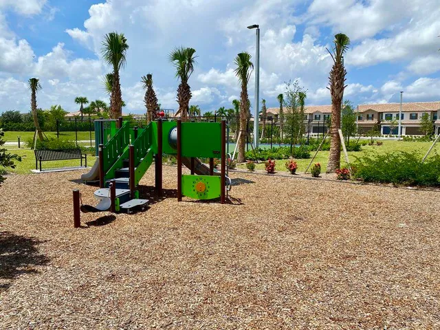 a view of a park with swings and slides