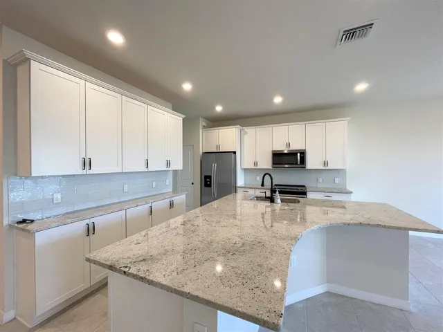 an empty room with a ceiling fan and window