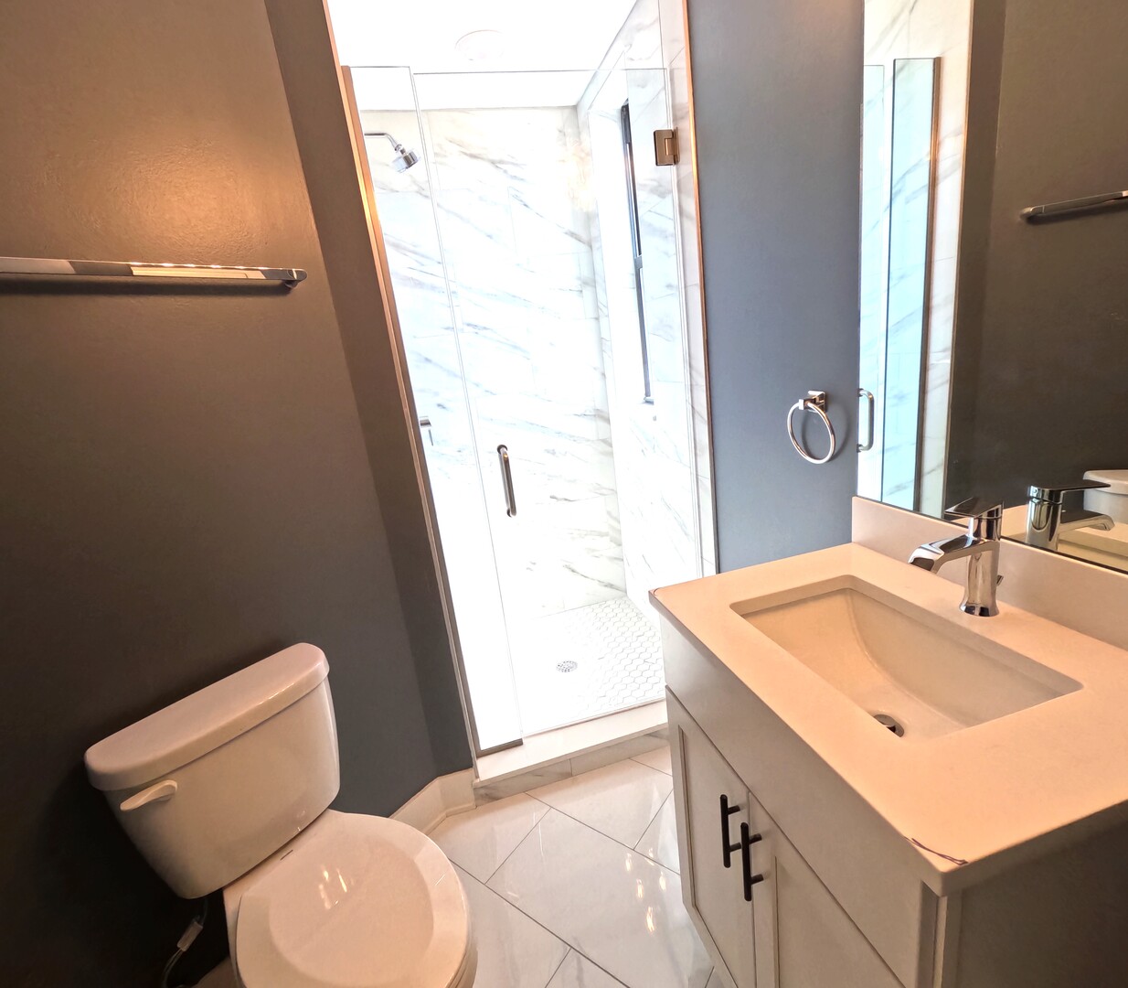 3473 South Archer Avenue, Unit 301 Chicago, IL 60608 - Photo 11 of 13 a bathroom with a toilet sink and mirror