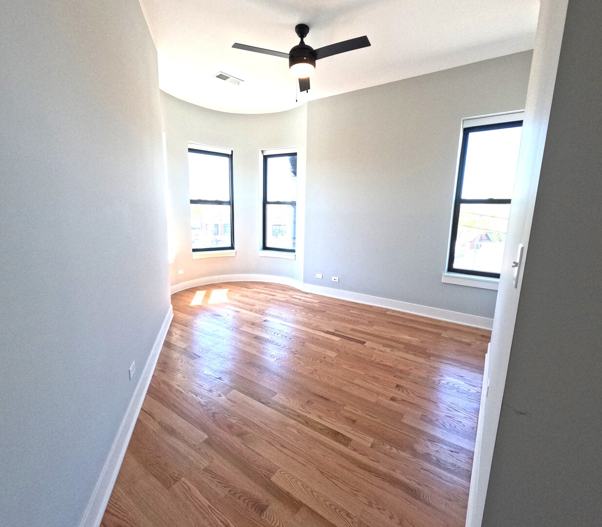 3473 South Archer Avenue, Unit 301 Chicago, IL 60608 - Photo 12 of 13 wooden floor in an empty room with a window