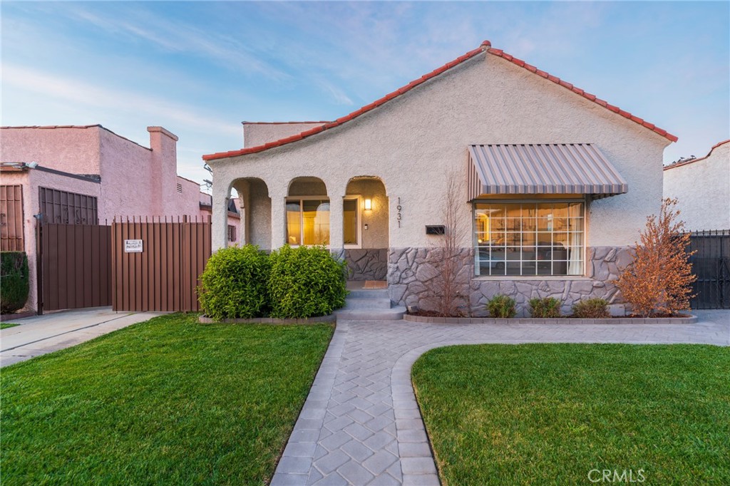 1931 West 68th Street Los Angeles, CA 90047 - Photo 1 of 29 a front view of a house with a garden and plants