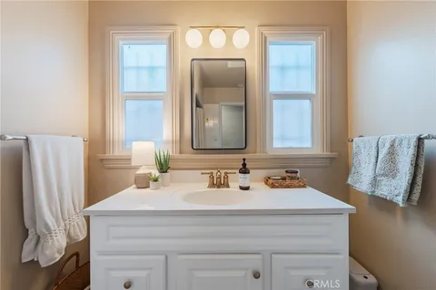 a bathroom with a sink vanity and a mirror