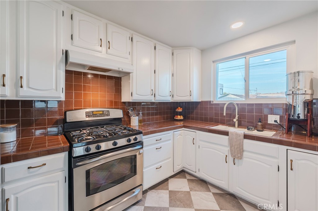 1931 West 68th Street Los Angeles, CA 90047 - Photo 13 of 29 a kitchen with granite countertop a sink stainless steel appliances and cabinets