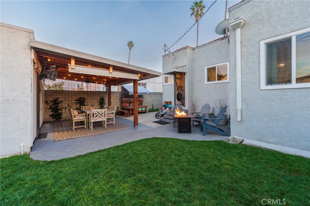 1931 West 68th Street Los Angeles, CA 90047 - Photo 20 of 29 a view of a backyard with table and chairs