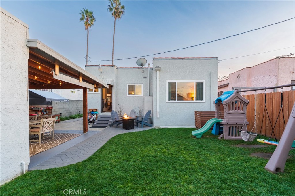 1931 West 68th Street Los Angeles, CA 90047 - Photo 21 of 29 a backyard of a house with table and chairs