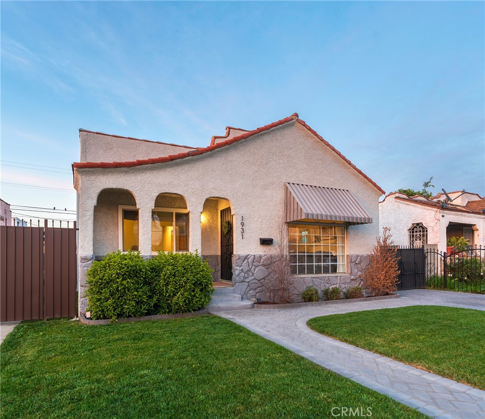 1931 West 68th Street Los Angeles, CA 90047 - Photo 28 of 29 a front view of a house with a garden