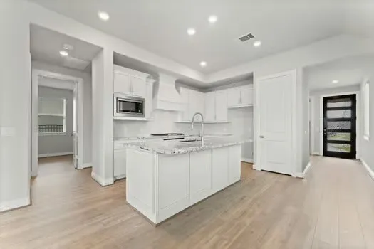 a kitchen with a sink stainless steel appliances and cabinets