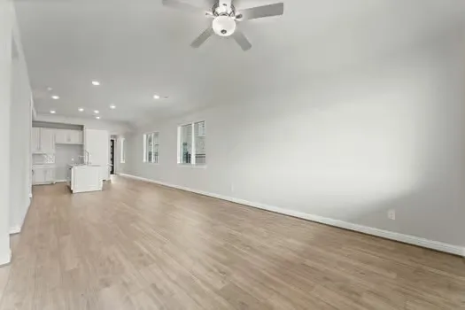 a view of a livingroom with a hardwood floor and a ceiling fan