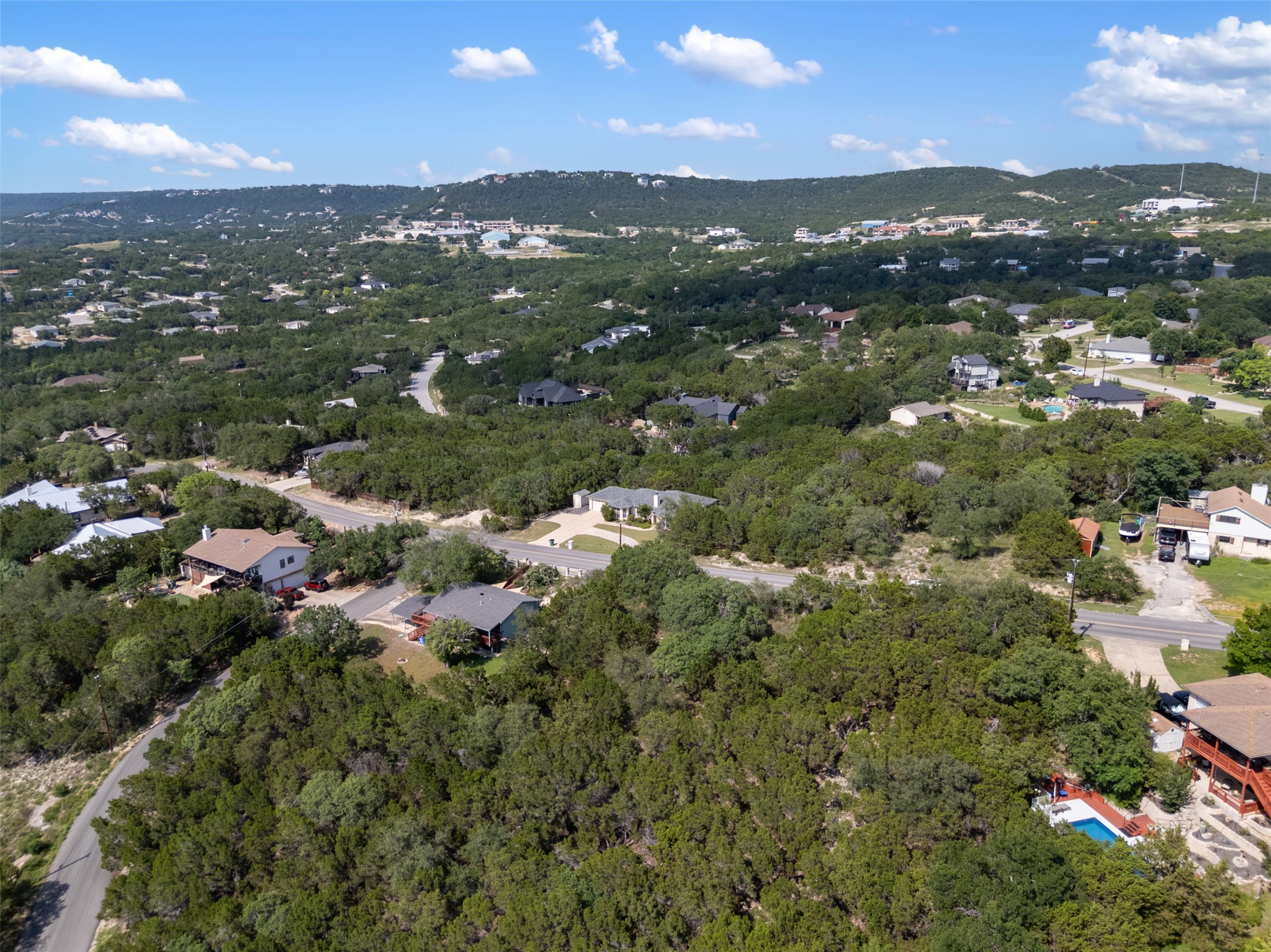 21105 Ridgeview Road Lago Vista, TX 78645 - Photo 13 of 34 Perched amidst verdant hills, this property offers serene vistas of a residential landscape.