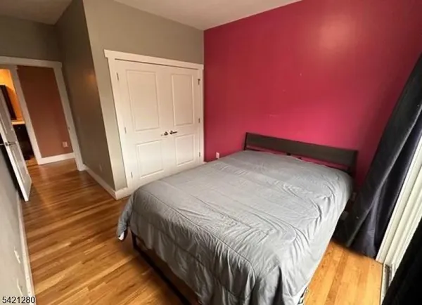 a bedroom with a bed and a mirror