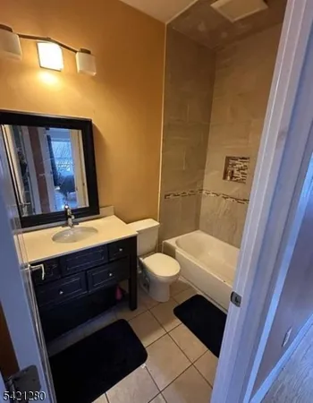 a bathroom with a sink a toilet a mirror and vanity