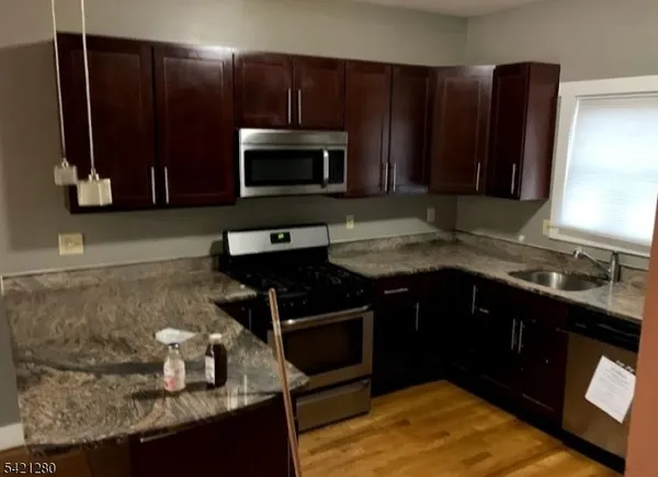 a kitchen with a sink stove and microwave