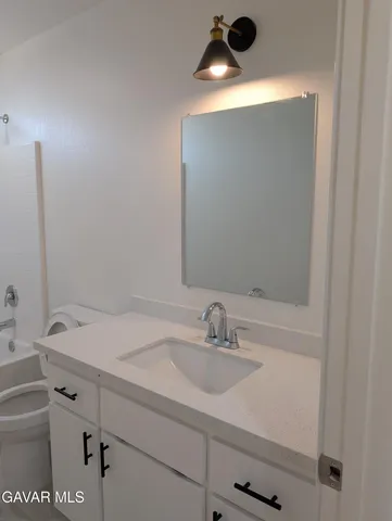 a view of empty room with wooden floor and fence