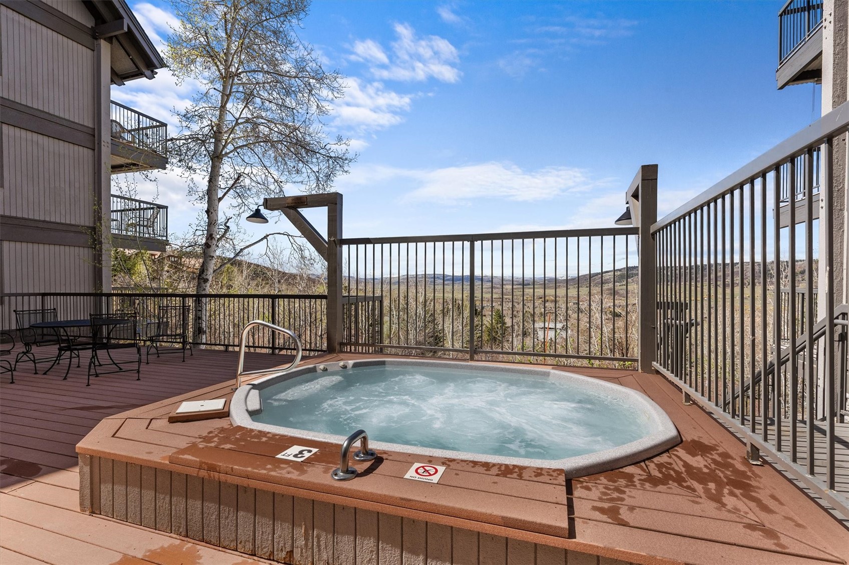 2602 Longthong Road, Unit 107 Steamboat Springs, CO 80487 - Photo 26 of 32 a balcony with table and chairs