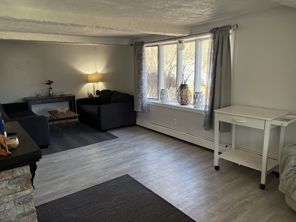227 Union Street Northbridge, MA 01588 - Photo 12 of 21 a living room with furniture and a window