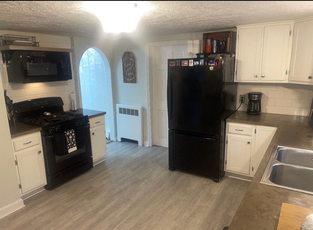 227 Union Street Northbridge, MA 01588 - Photo 7 of 21 a kitchen with a refrigerator and cabinets