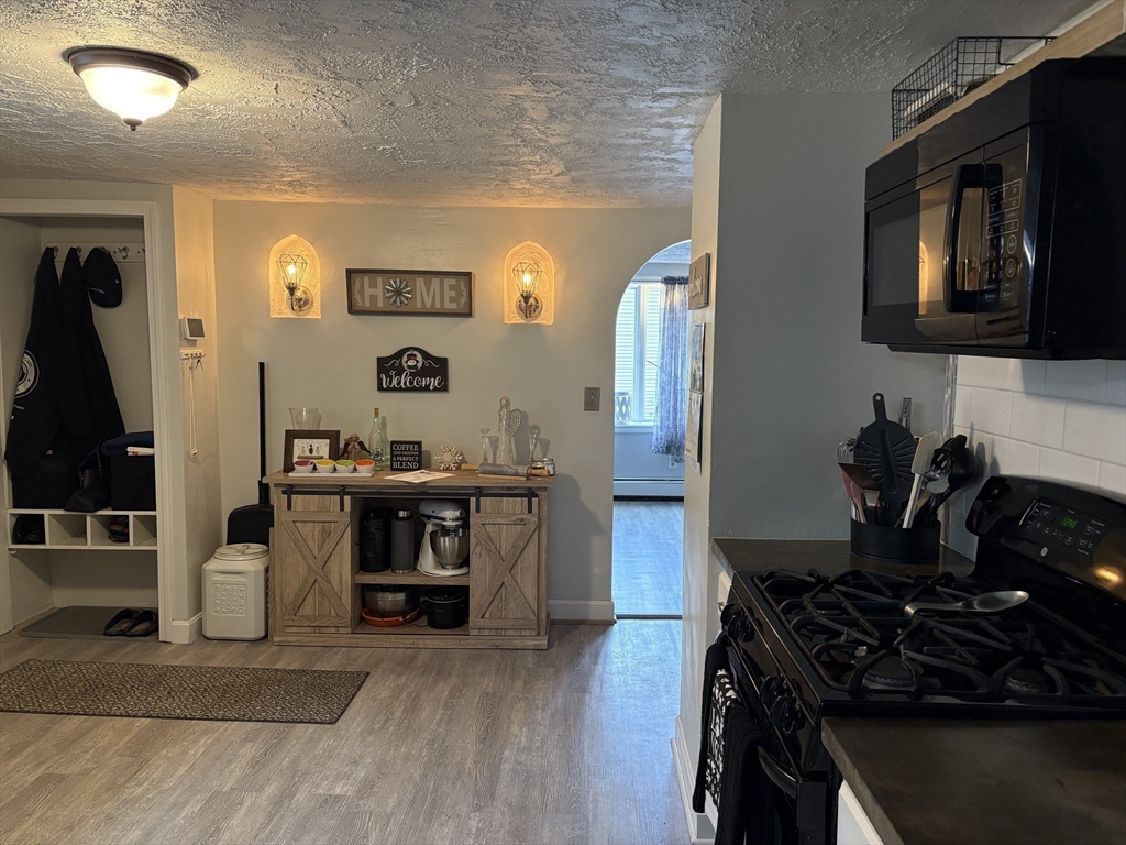 227 Union Street Northbridge, MA 01588 - Photo 8 of 21 a kitchen with granite countertop a stove and a refrigerator