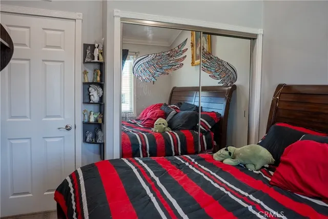 a bedroom with two bed and a closet