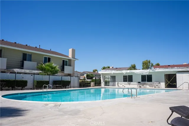 a front view of a house with a garden and plants