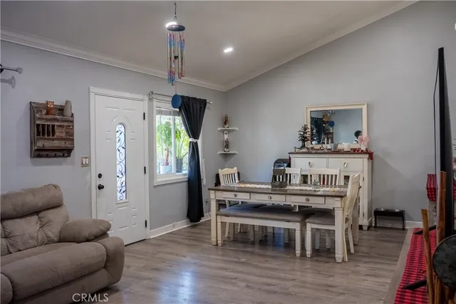 a living room with furniture a dining table and a wooden floor