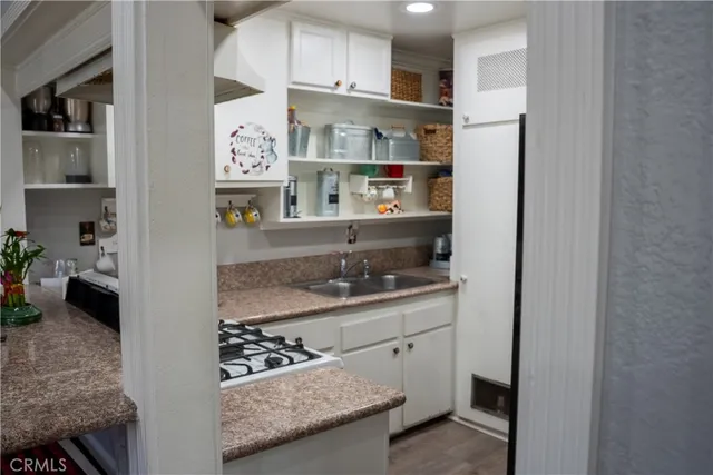 a kitchen with stainless steel appliances granite countertop a refrigerator and a stove