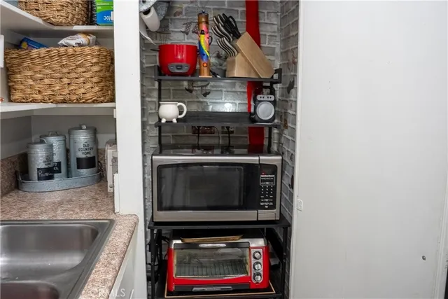 a kitchen with stainless steel appliances granite countertop a stove and a microwave