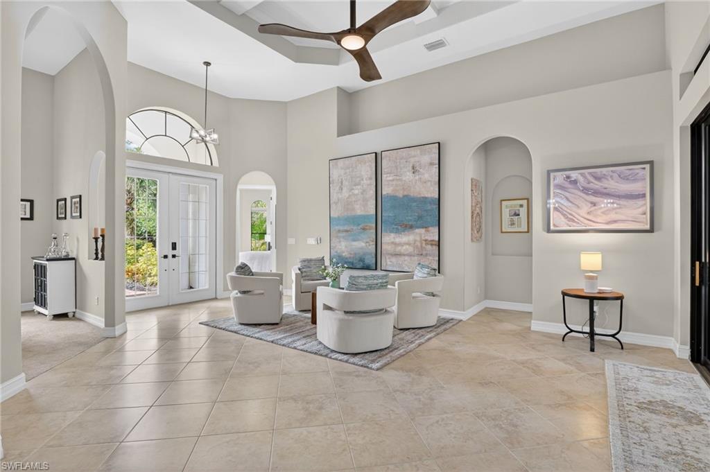 2360 19th Street Southwest Naples, FL 34117 - Photo 13 of 43 a living room with furniture and a chandelier