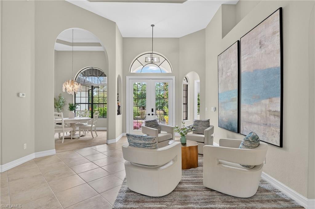 2360 19th Street Southwest Naples, FL 34117 - Photo 14 of 43 a living room with a large window and chandelier
