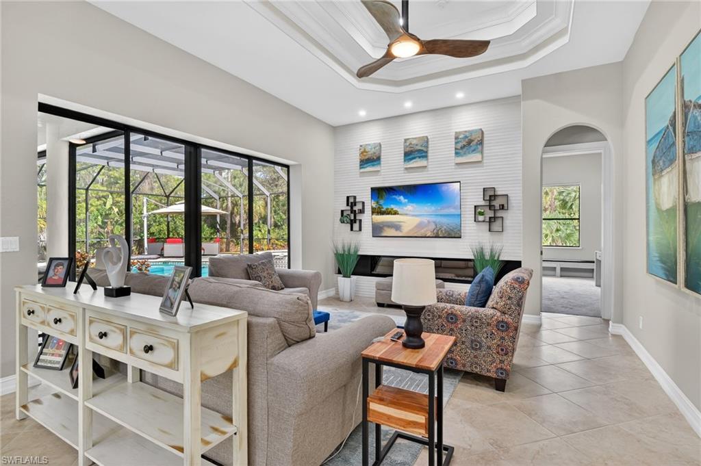 2360 19th Street Southwest Naples, FL 34117 - Photo 19 of 43 a living room with furniture large window and wooden floor