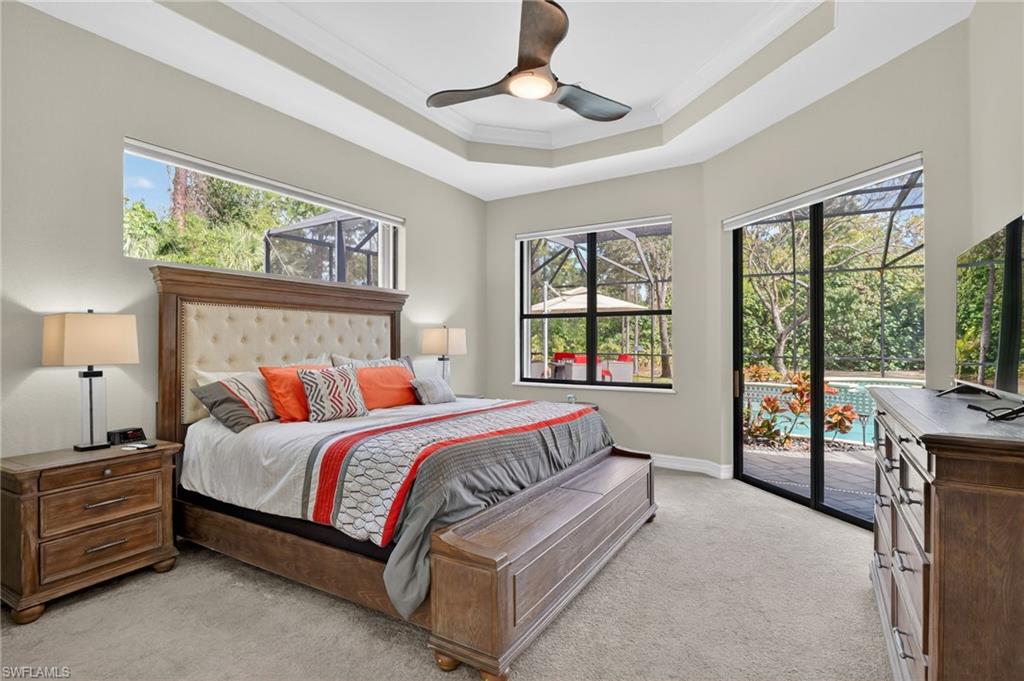 2360 19th Street Southwest Naples, FL 34117 - Photo 20 of 43 a bed room with a bed and a chandelier