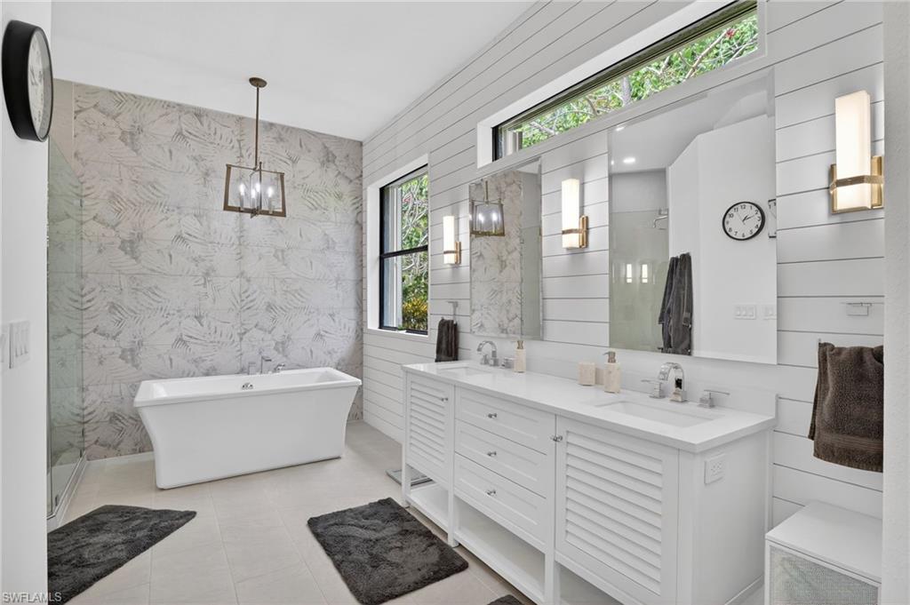 2360 19th Street Southwest Naples, FL 34117 - Photo 22 of 43 a bathroom with a double vanity sink mirror and bathtub