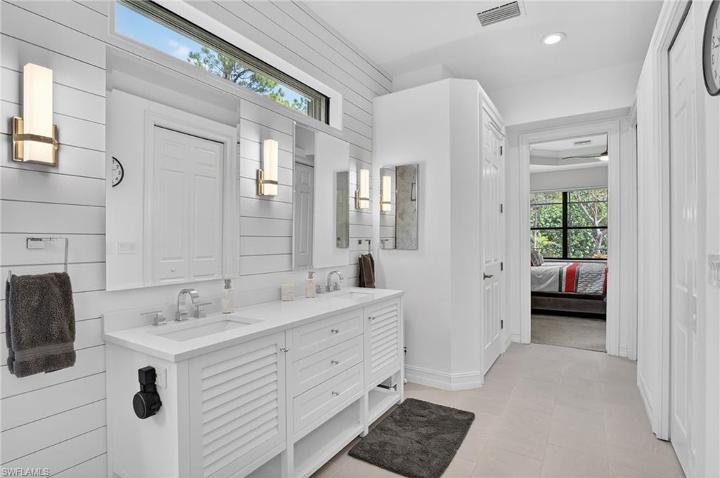 2360 19th Street Southwest Naples, FL 34117 - Photo 23 of 43 a spacious bathroom with a double vanity sink a mirror and shower