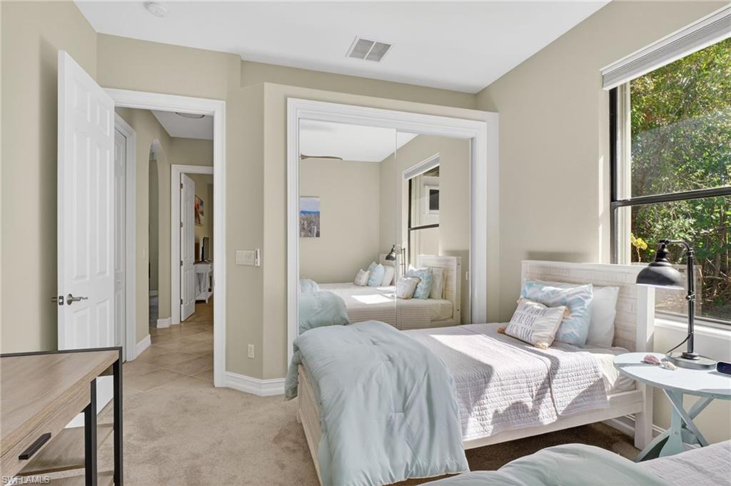 2360 19th Street Southwest Naples, FL 34117 - Photo 26 of 43 a bedroom with a bed and a large mirror