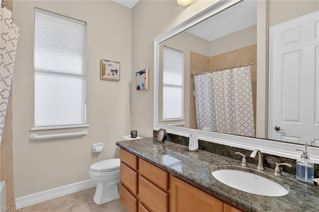 2360 19th Street Southwest Naples, FL 34117 - Photo 36 of 43 a bathroom with a granite countertop sink toilet and mirror