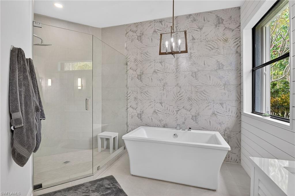 2360 19th Street Southwest Naples, FL 34117 - Photo 4 of 43 a bathroom with a bathtub and shower