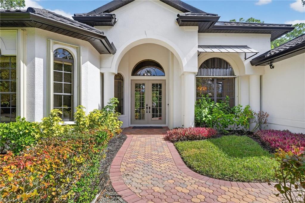 2360 19th Street Southwest Naples, FL 34117 - Photo 9 of 43 a view of a house with potted plants