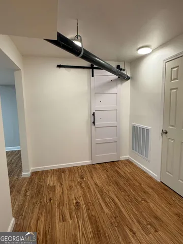 a view of a room with wooden floor