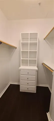 a view of a room with wooden floor and a window