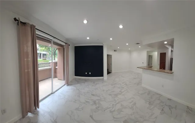 a kitchen with stainless steel appliances granite countertop a refrigerator sink and stove