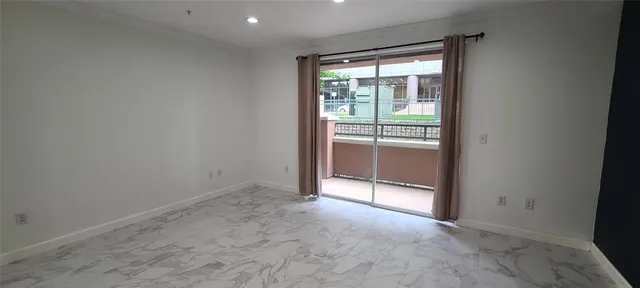 an empty room with sliding glass door